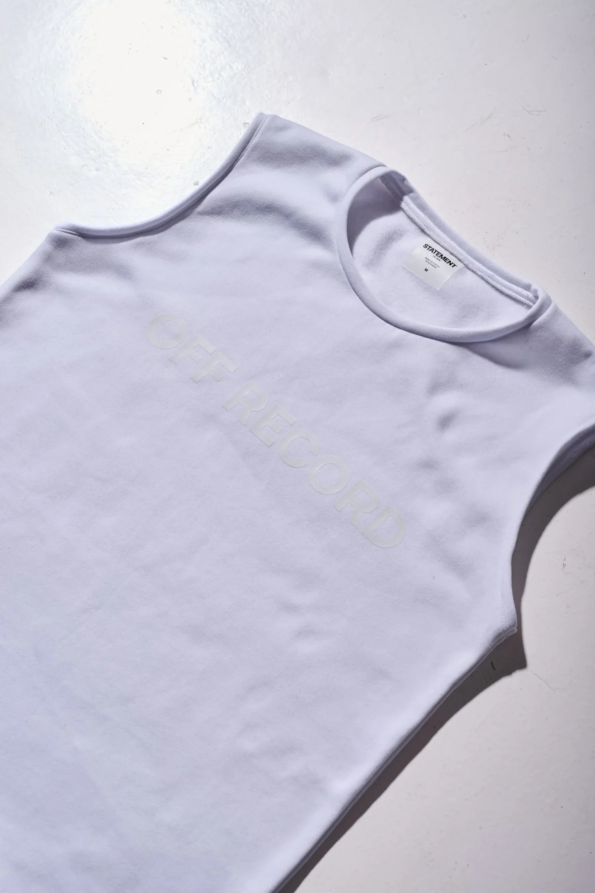 boxy off-white sleeveless t-shirt