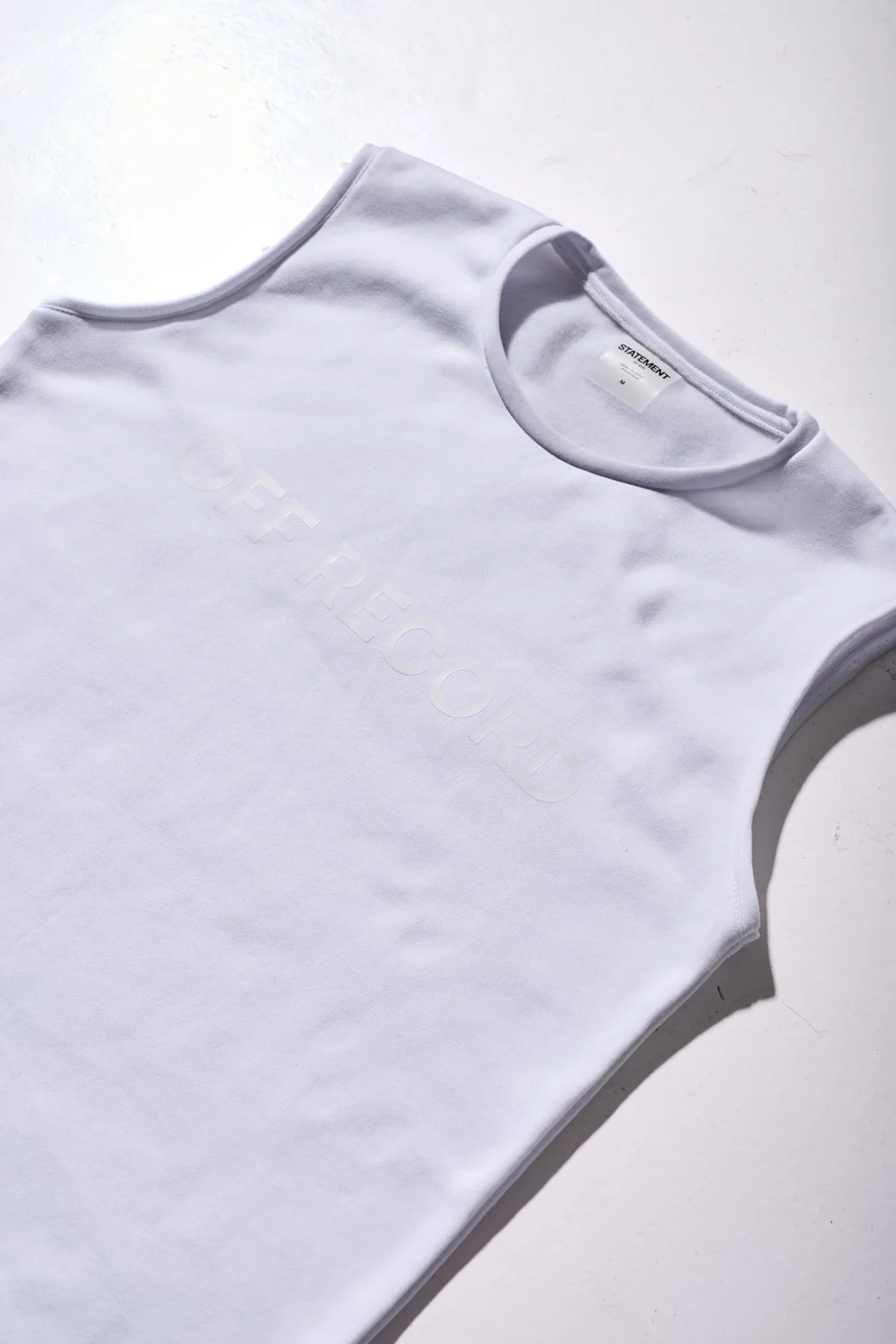 boxy off-white sleeveless t-shirt