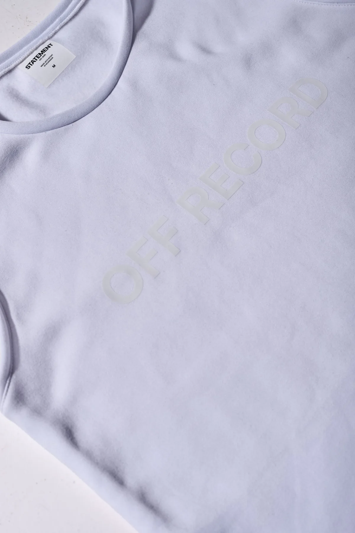 boxy off-white sleeveless t-shirt