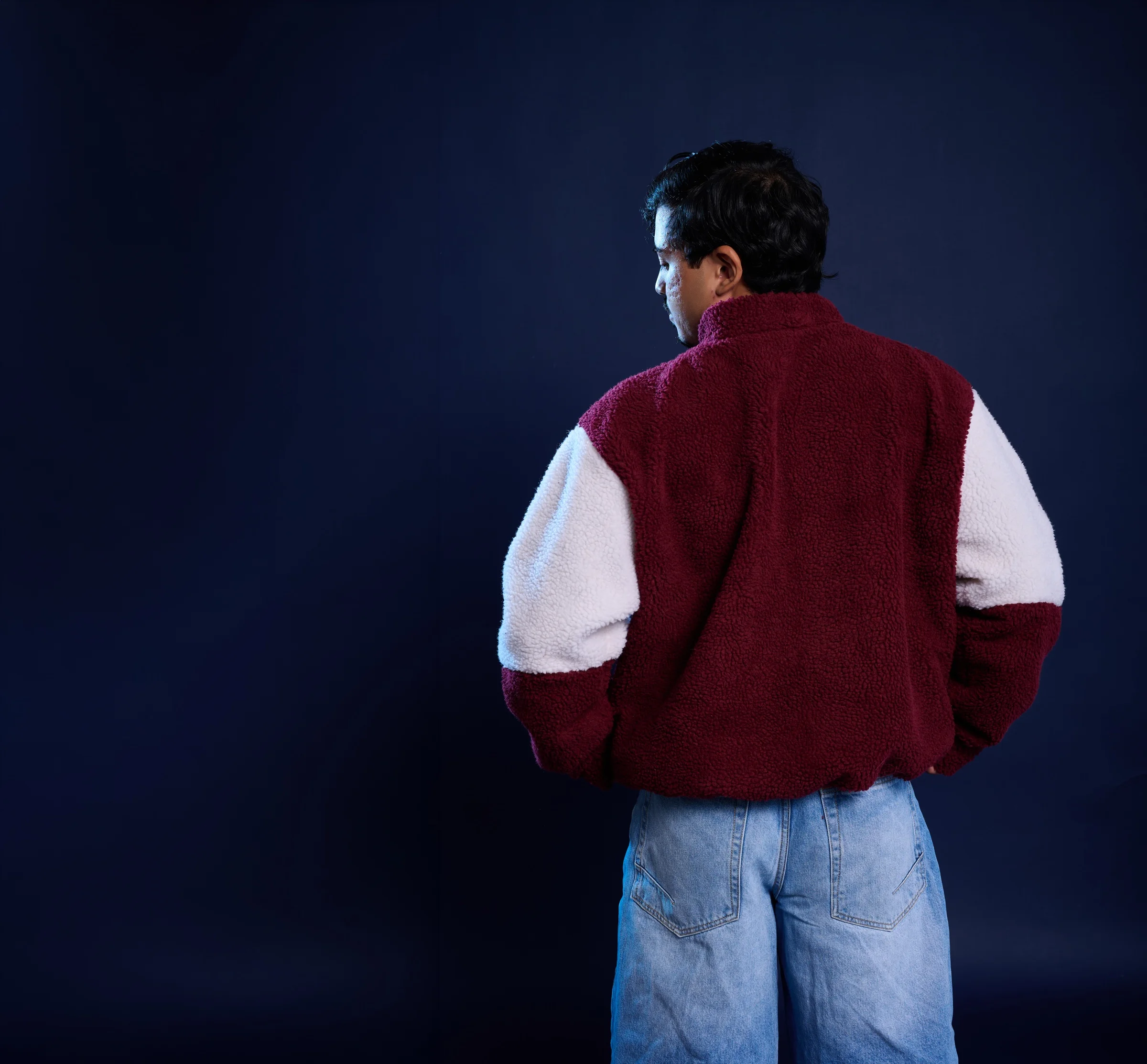 Model wearing the STATEMENT patchwork sherpa jacket, seen from behind